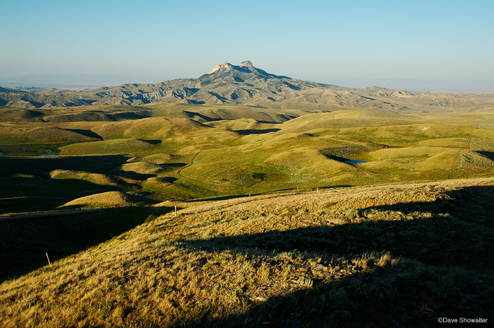 Evening shadows and rolling sagebrush surrounding Heart Mountain, an icon of the A-B Front. The Nature Conservancy's Heart Mountain...