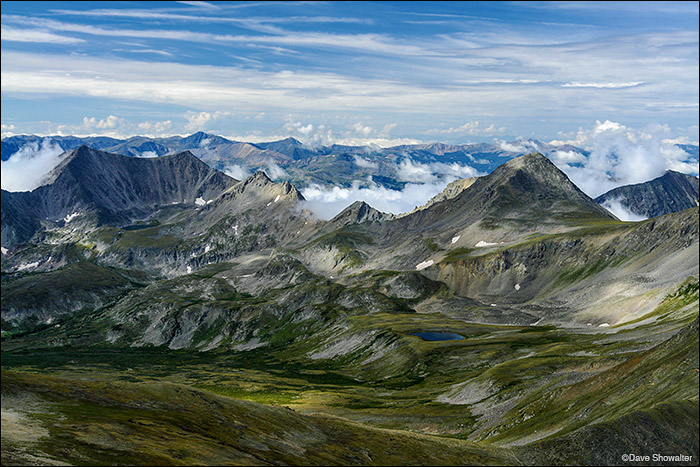 Iowa Peak, 13,831' rises above low-hanging clouds in this early morning view from the summit of Mount Belford. The Sawatch range...