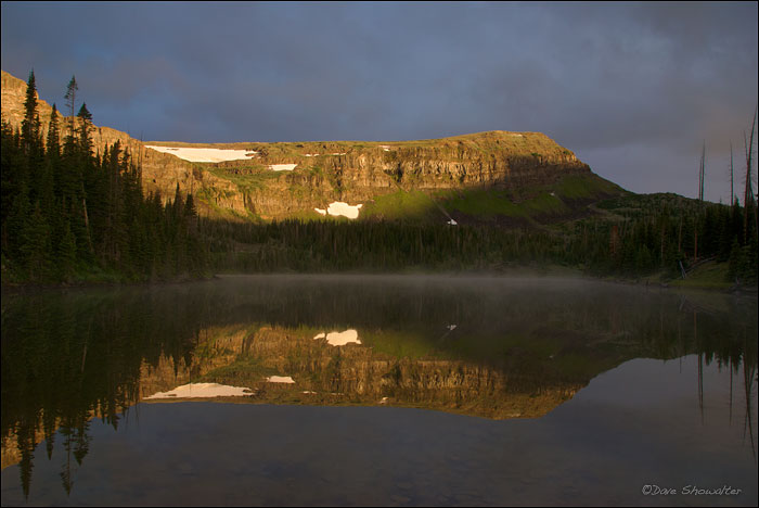 Early morning light breaks through lingering storm clouds to illuminate a high ridge in the Flat Tops Wilderness Area. Hooper...