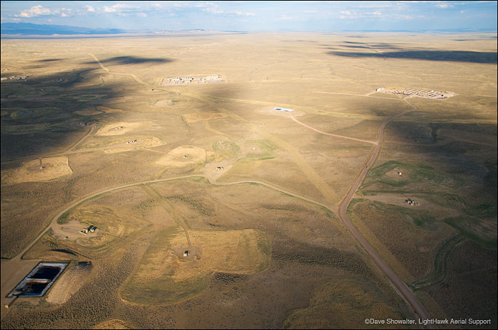 &nbsp;Roads, gas drilling pads, produced water ponds, and compressor stations fragment the land in this aerial view of the Jonah...