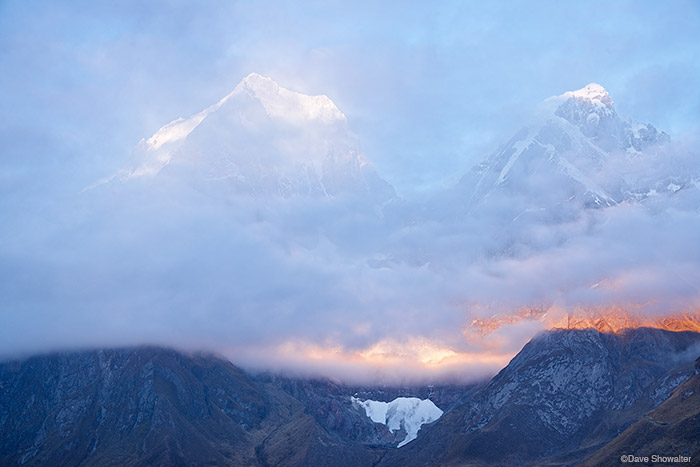 Early morning light breaks through layers of clouds to reveal Yerupaja (6634m) and Yerupaja Chico (6121m) from &nbsp;Carhuacocha...