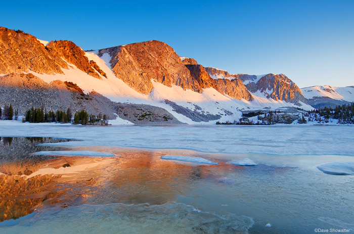 &nbsp;Old Main and the face of the Snowy range reflected in Lake Marie ice, early July.