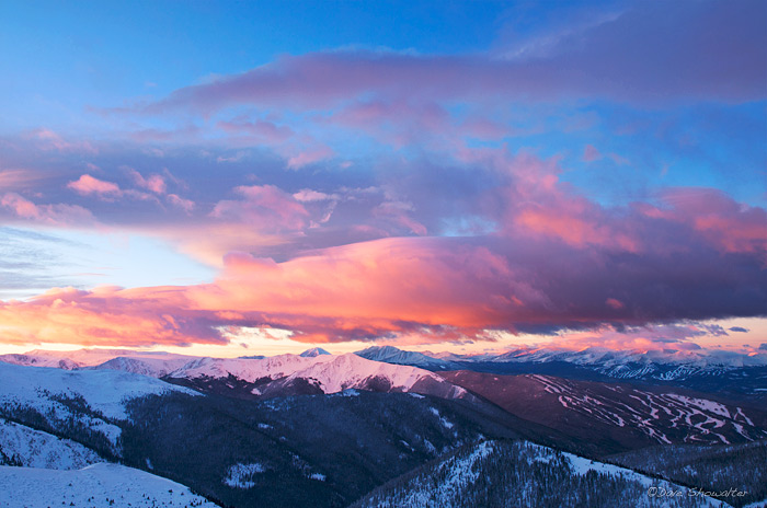 From a high alpine ridge above Loveland Pass, a winter sunrise lights the Tenmile-Mosquito ranges over A-Basin and Breckenridge...