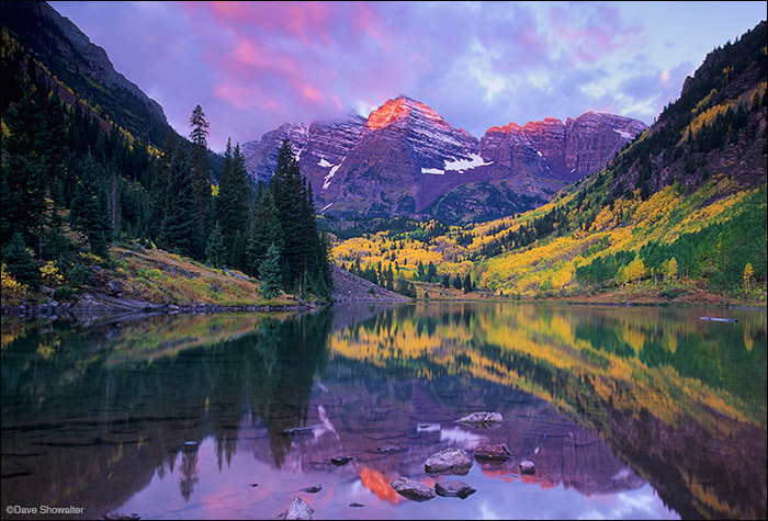 Maroon Peak, 14156' and North Maroon Peak, 14,014' are reflected in Maroon Lake at sunrise. The view of The Bells from Maroon...