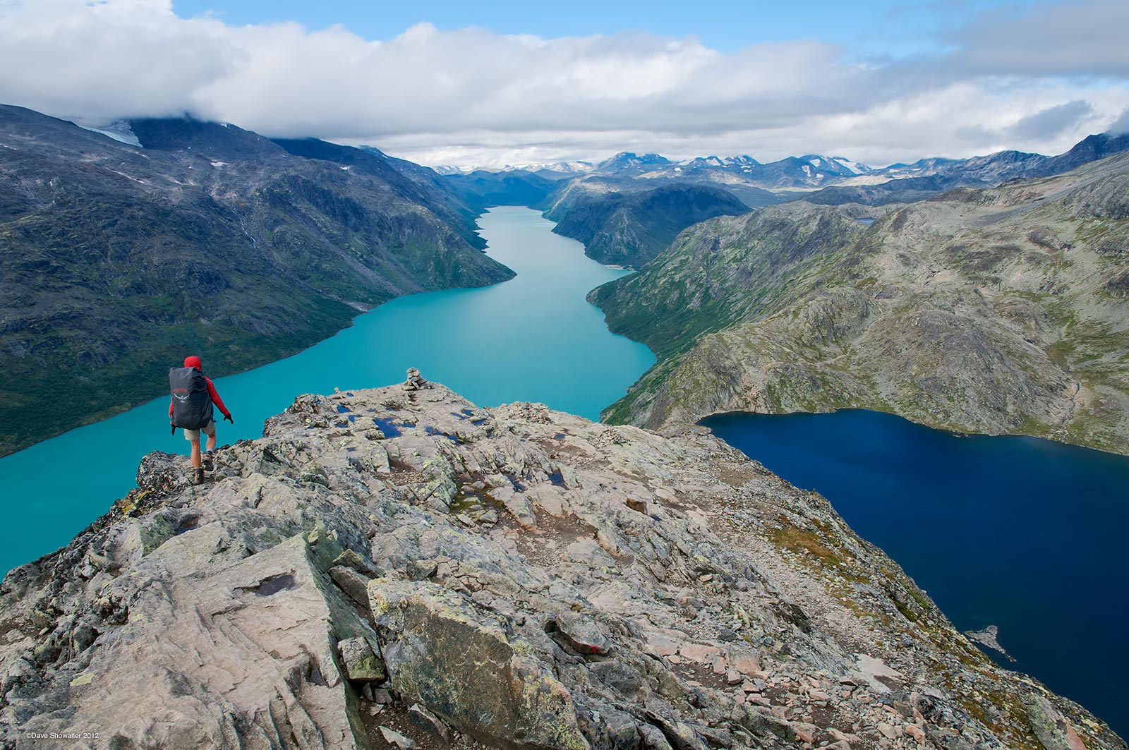 Trekking hut to hut in Jottenheimen, Norway's "Land Of The Giants", Marla crests Bessegen Ridge with snow-capped peaks in the...