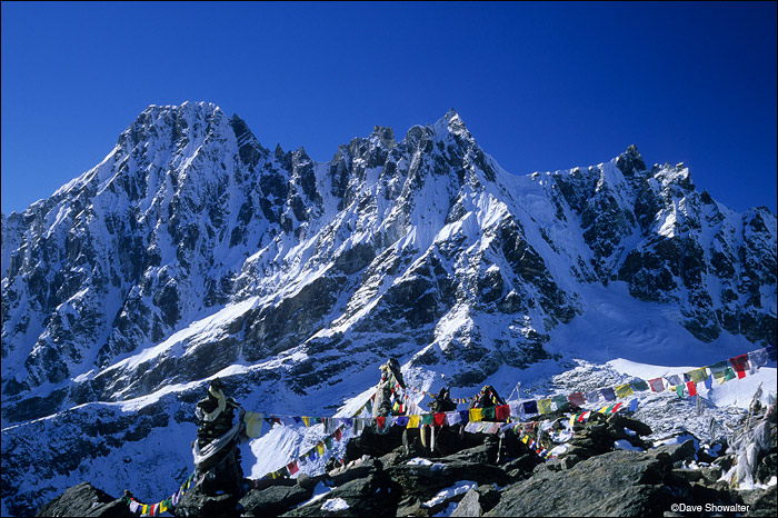 &nbsp;Buddhist prayer flags adorn the foreground on Gokyo Ri's summit (5357m,17,575')&nbsp;with a backdrop of Phari Lapche Peak...