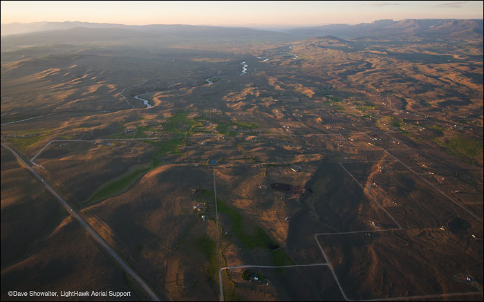 This aerial view north of Pinedale, Wyoming shows the residential development along the Upper Green River. The development overlaps...