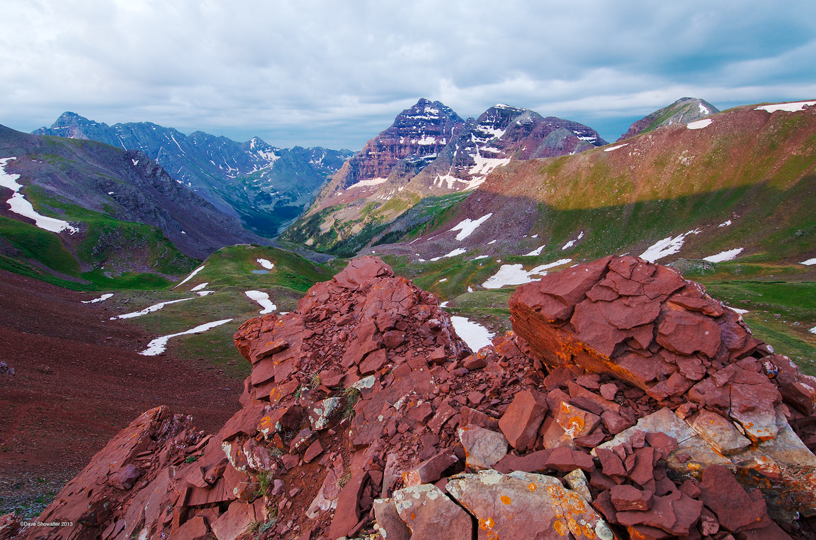 From well above timberline on Willow Pass, a sunbreak after a morning thunderstorm lights the Maroon Bells and Pyramid Peak (...