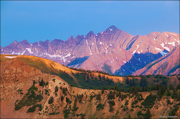 Castle Peak, 14,265' gathers pink sunrise light from this Taylor Pass viewpoint. Conundrum, a sub-peak and named 14'er, stands...