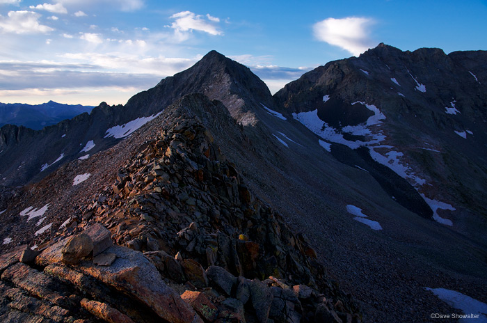 &nbsp;Morning light breaks through clouds just after sunrise and grazes the flank of Gladstone Peak (13,913') and Mount Wilson...