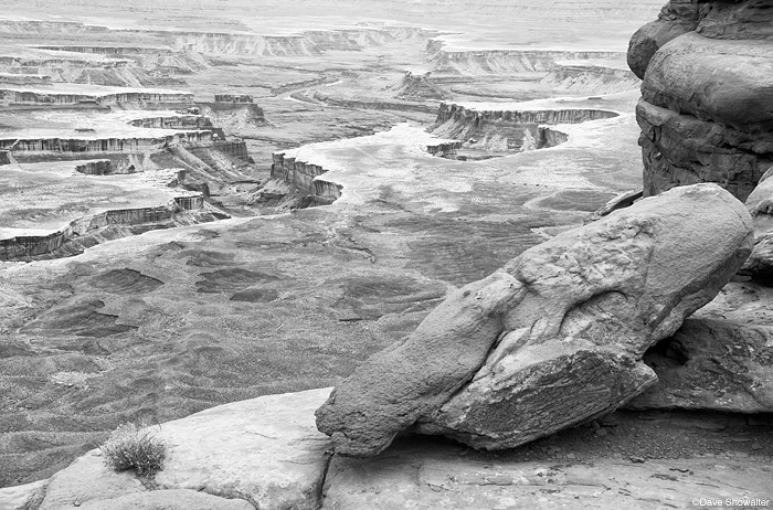 A boulder hangs on the rim of Island In The Sky at the Green River Overlook in Canyonlands National Park, Utah. The power of...