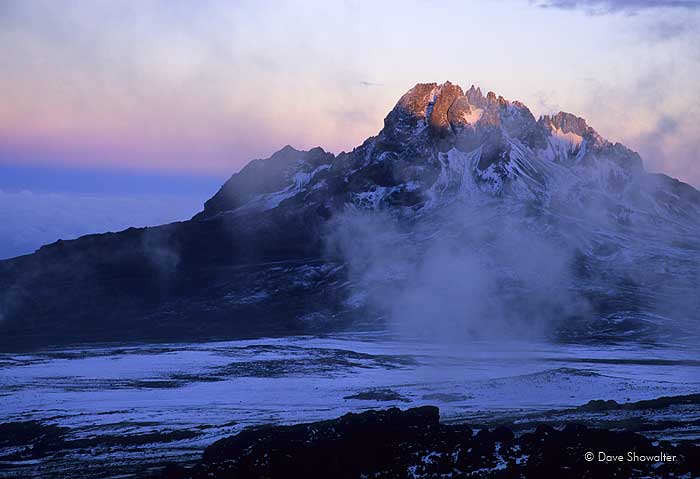 As a snowstorm passes, sunset lights Kibo just before sunset. Kibo is the smaller sibling peak to Uruhu on Kilimanjaro.&nbsp;