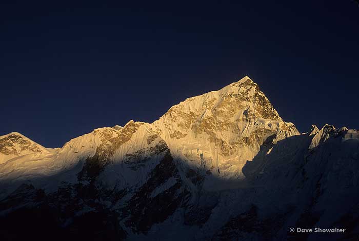 Nuptse, 7,881 meters is spotlit by late afternoon sunlight. This Himalayan giant guards Mount Everest and Lhotse in this view...