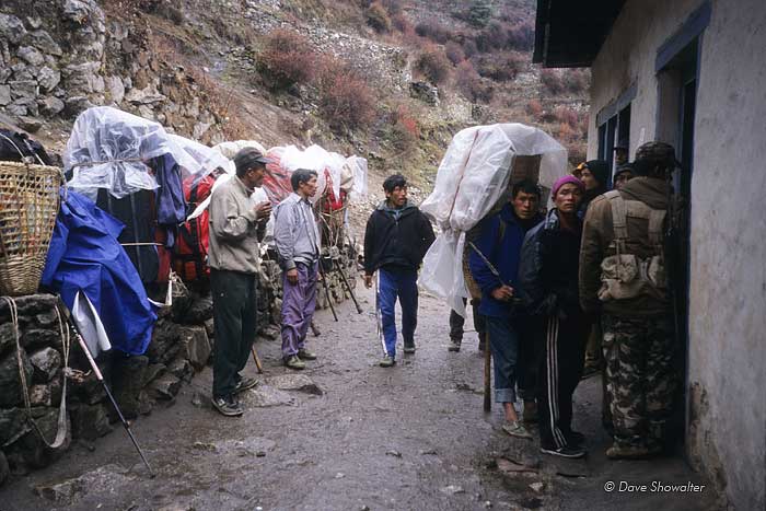 Porters rest their loads at the check-in to Sagarmatha (Everest) National Park at Namche Bazaar .