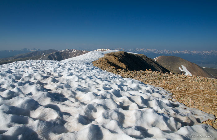 Sun-cupped snow lines the high ridege to Mount Sherman's summit. This 14,036' peak is considered by many to be Colorado's easiest...