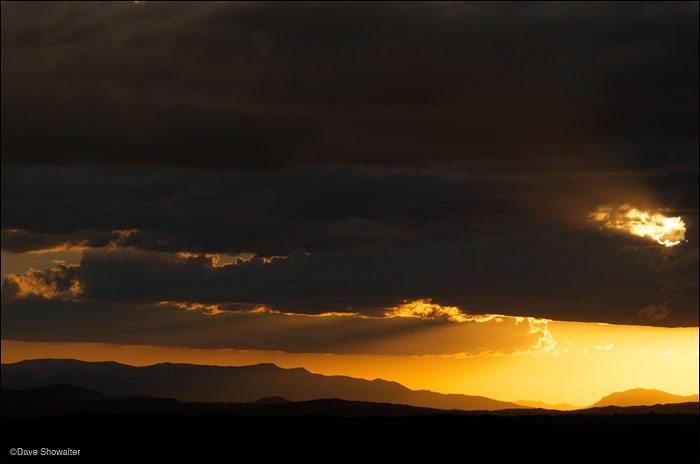 &nbsp;Sunset breaks through storm clouds above the Wyoming range.