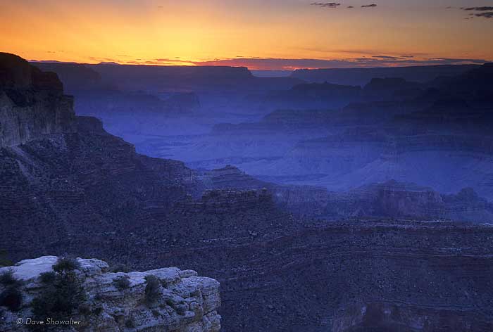 The Grand Canyon fades to darkness as a golden sunset disappears behind the North Rim.