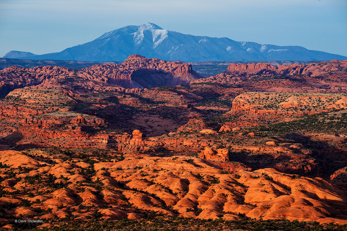 Sunset sidelights shapes of red rock and the Henry Mountains over the Escalante River from Egypt Trailhead. Here, where water...