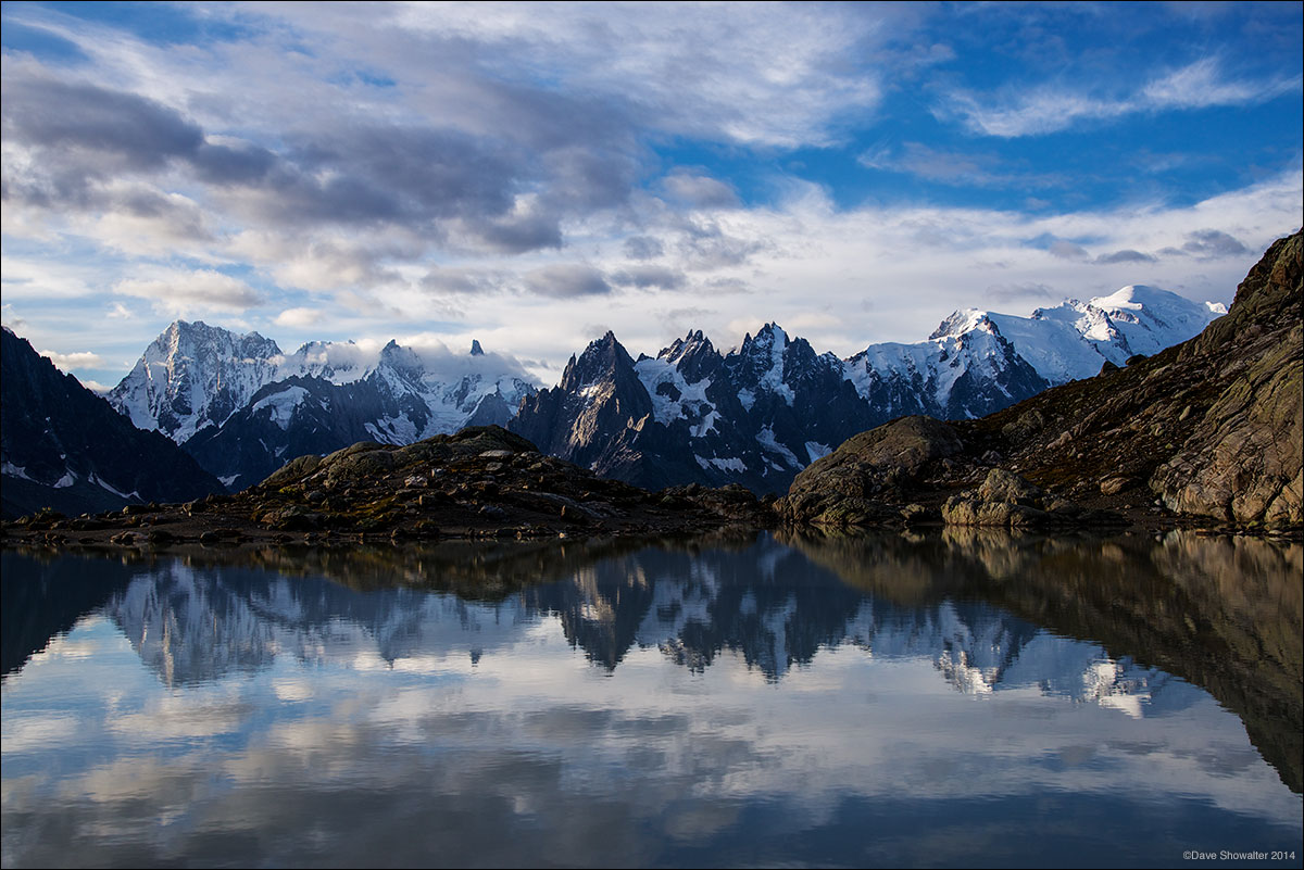 Mont Blanc, Chamonix Pinnacles, and the Grand Jorasses - the Mont Blanc massif are reflected in still waters of Lac Blanc. Refuges...