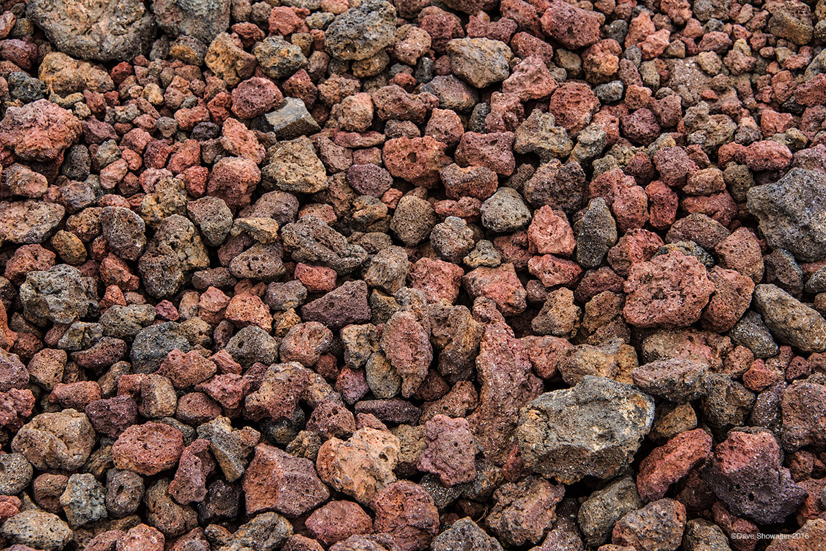 Iron rich scoria lava rocks, once small bodies of magma that flew through the air during an eruption, have colorfully oxidized...