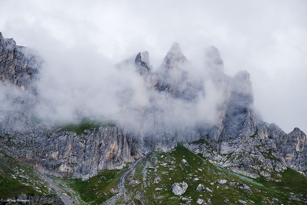 Clouds swirl around pinnacles of Aguille de la Pennaz on the Tour Du Mont Blanc. Pennaz (2,648m) seems impossibly high when hiking...