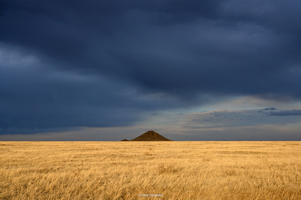 Like a distant pyramid, a volcanic remnant rises above golden Soapstone Prairie, a Great Plains jewel on the Front Range north...