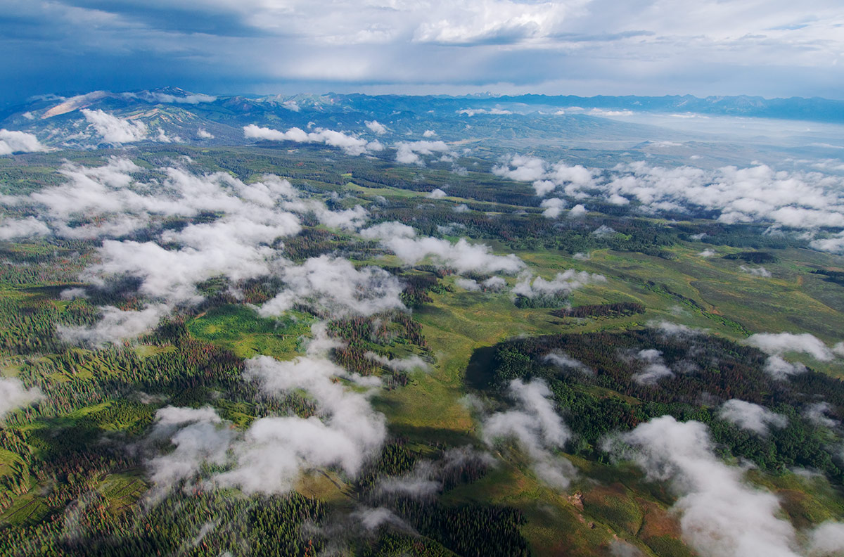 &nbsp;Puffy clouds linger over the Wyoming Range as a violent thunderstorm moves over the Teton Range to the north. I was flying...