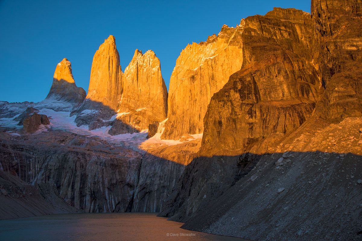 Glowing vertical spires&nbsp;and Torres Del Paine namesake&nbsp;are painted in gold at first light. It's a burly alpine start...