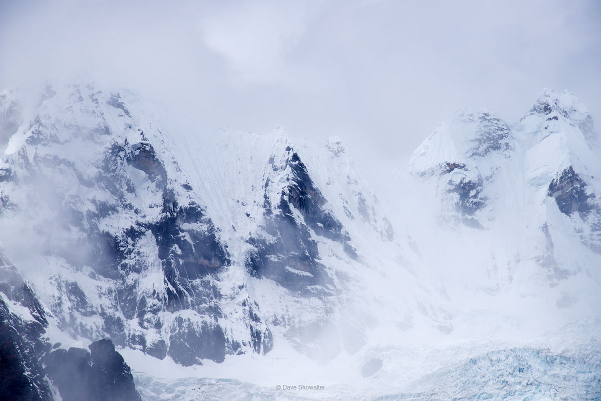 Storm clouds swirl around the sheer rock faces of Rondoy (L, 5870m) and Jirishanca (6094m) from Laguna Jahuacocha, the last camp...